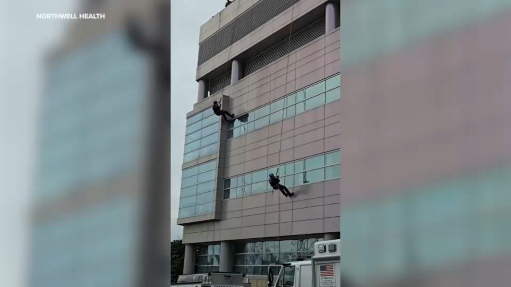 Police officers rappel off roof of Cohen's Children Medical Center to deliver holiday gifts to children