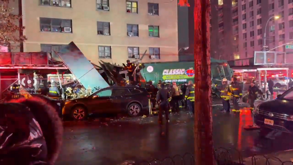 Sanitation truck crashes into scaffolding surrounding East Harlem apartment building