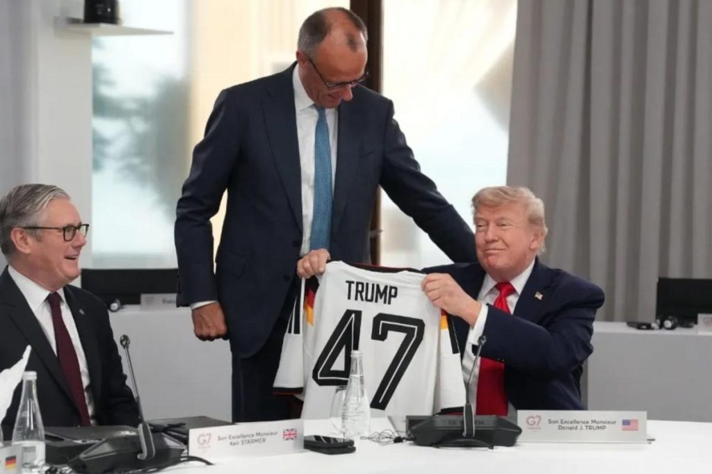 German Chancellor Friedrich Merz gives Trump a 'TRUMP 47' soccer jersey as belated birthday gift at G7 summit